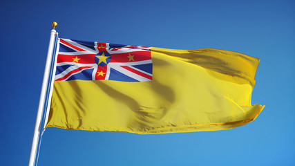 Niue flag waving against clean blue sky, close up, isolated with clipping path mask alpha channel transparency
