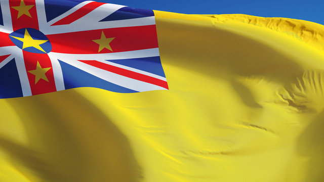 Niue flag waving against clean blue sky, close up, isolated with clipping path mask alpha channel transparency