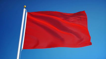 Fototapeta na wymiar Red flag waving against clean blue sky, close up, isolated with clipping path mask alpha channel transparency