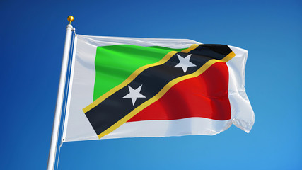 Naklejka premium Saint Kitts and Nevis flag waving against clean blue sky, close up, isolated with clipping path mask alpha channel transparency