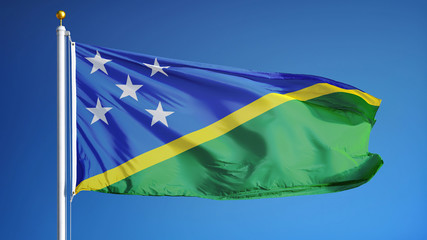 Solomon Islands flag waving against clean blue sky, close up, isolated with clipping path mask...