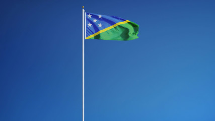 Solomon Islands flag waving against clean blue sky, long shot, isolated with clipping path mask alpha channel transparency