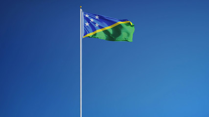 Solomon Islands flag waving against clean blue sky, long shot, isolated with clipping path mask alpha channel transparency