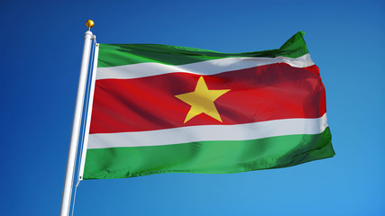 Fototapeta na wymiar Suriname flag waving against clean blue sky, close up, isolated with clipping path mask alpha channel transparency