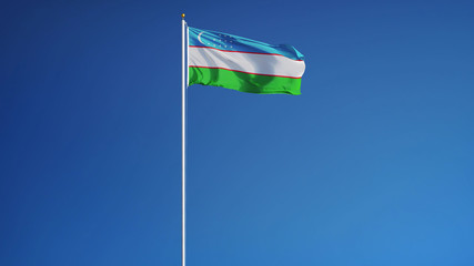 Uzbekistan flag waving against clean blue sky, long shot, isolated with clipping path mask alpha channel transparency
