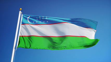 Uzbekistan flag waving against clean blue sky, close up, isolated with clipping path mask alpha channel transparency