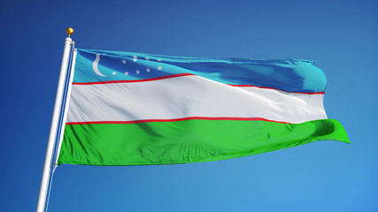Uzbekistan flag waving against clean blue sky, close up, isolated with clipping path mask alpha channel transparency