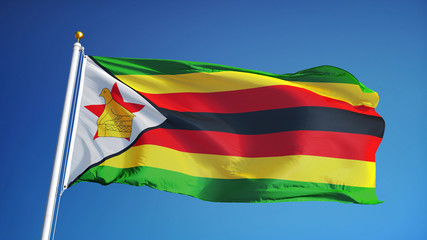 Zimbabwe flag waving against clean blue sky, close up, isolated with clipping path mask alpha...