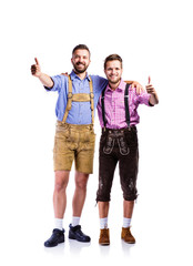 Two hipster men in traditional bavarian clothes, studio shot
