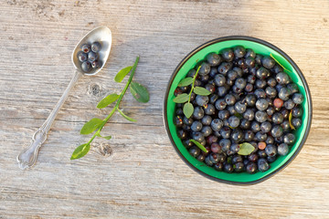 Blueberry in a bowl and a silver spoone from above
