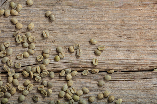 Green Coffee Beans On A Wooden Background