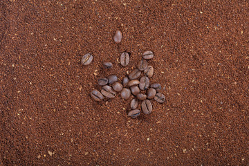 Fototapeta na wymiar Coffee beans on ground coffee background
