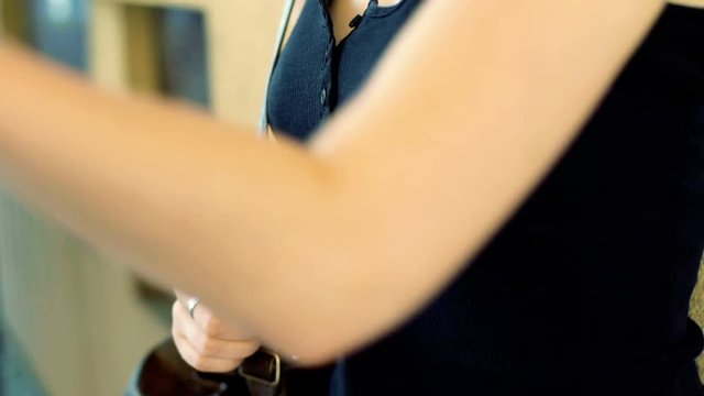 Punk girl standing next to the wall and chewing a gum, steadycam shot
