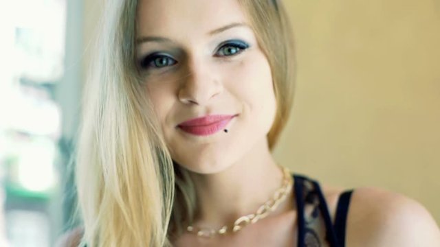 Beautiful, punk girl smiling to the camera, steadycam shot
