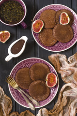 Chocolate pancakes with chocolate sauce and figs   