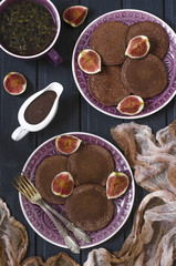 Chocolate pancakes with chocolate sauce and figs   