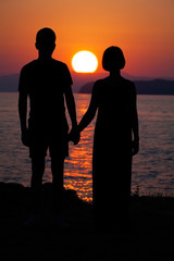 Man and Woman in Love. Silhouette of Couple during Sunset