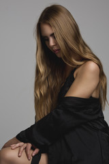 studio portrait of attractive young woman with long hair