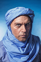 Berber man wearing blue turban. Studio shot.