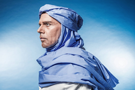 Profile View Of Berber Man Wearing Blue Turban With White Robe.