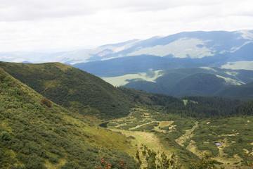 Fototapeta na wymiar View of mountain peak and green meadow