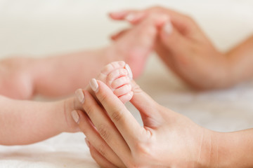 Massage cute feet of baby