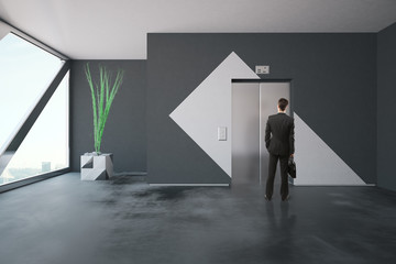 Businessman in front of elevator