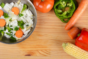 Vegetables and seasonings on wooden table.