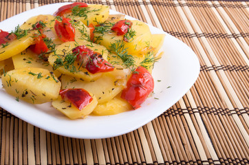 Closeup view on slices of potato stew with vegetables