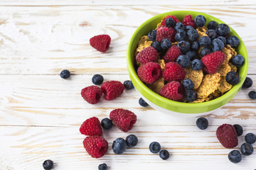 Healthy corn flakes breakfast on the white wooden table