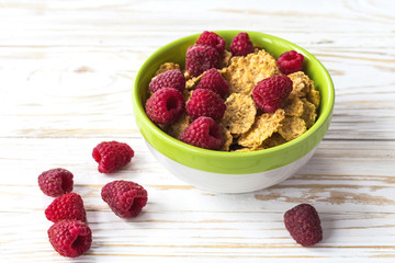 Healthy corn flakes breakfast on the white wooden table