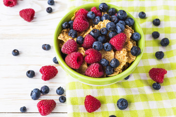 Healthy corn flakes breakfast on the white wooden table