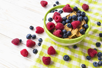 Healthy corn flakes breakfast on the white wooden table