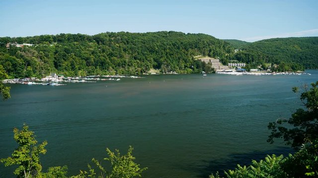 4K time lapse movie of small craft and speed boats moving around the Cheat Lake near Morgantown in West Virginia on Labor Day. Docks and Marina and wooded hillsides in the background