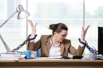Woman chained to her working desk