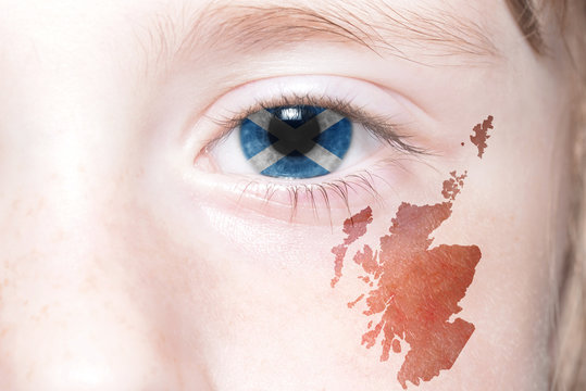 human's face with national flag and map of scotland.