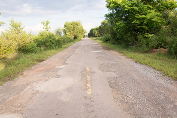 Fototapeta na wymiar Damaged asphalt pavement road with potholes ,Asia
