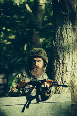 Fototapeta premium Young soldier with gun