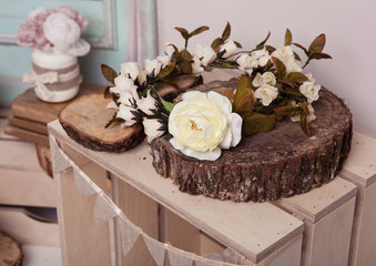 White rose on wooden plate on wooden box