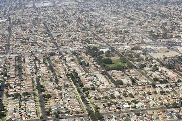 Fototapeta premium Aerial view of Los Angeles in the United States City landscape with roofs of houses and roads. 