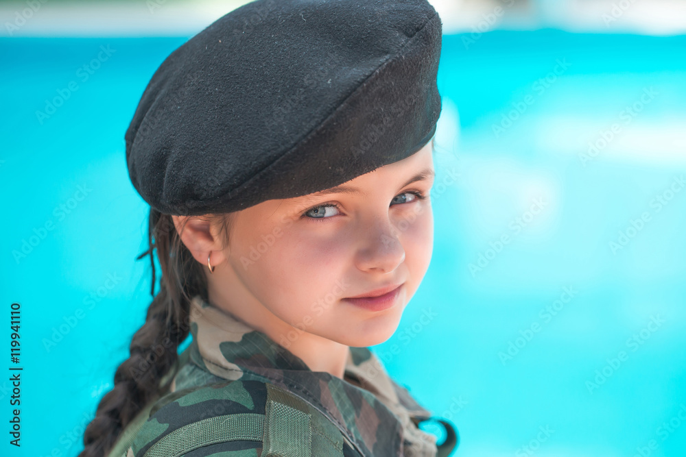 Wall mural Young girl in army ammunition