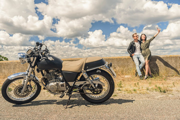 Young couple traveling by motorcycle