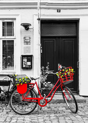 Retro vintage red bicycle on cobblestone street in the old town. © Ilgov