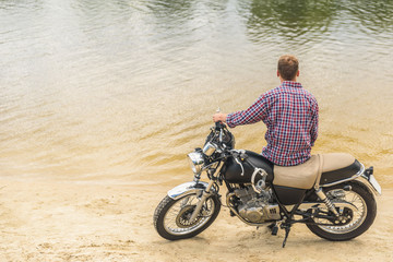 Young man sitting on his motorbike