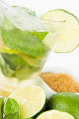 Mojito in a glass and ingredients on a white background