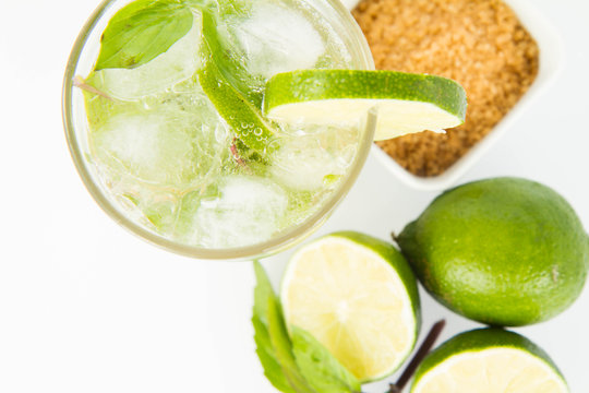 Mojito in a glass and ingredients on a white background