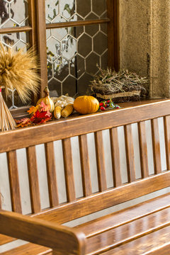 window sill with autumnal decoration (pumpkin, corn, maple leave