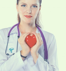 Young woman doctor holding a red heart, isolated on white background
