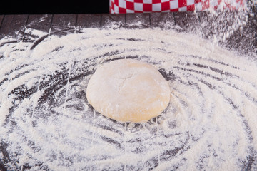 Cook preparing dough for baking in the kitchen