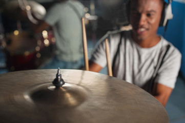 Drummer in action inside studio